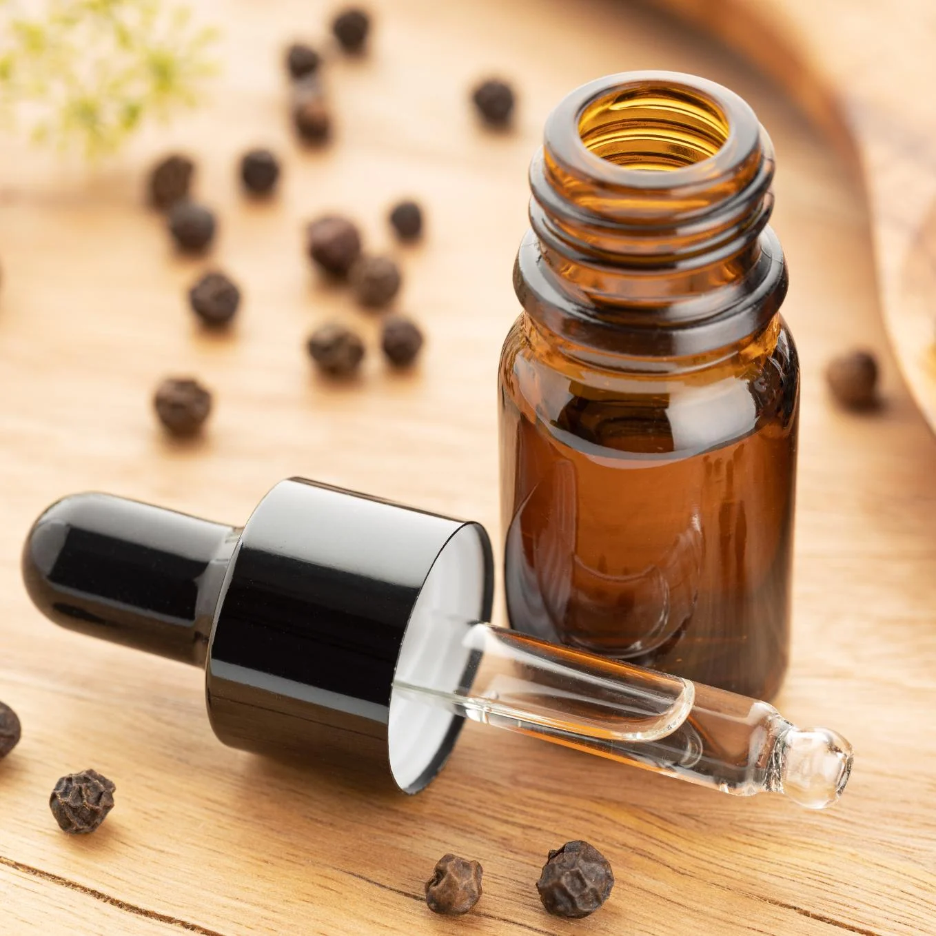 black-pepper-essential-oil-bottle-wooden-table-peppercorn-oil-alternative-medicine